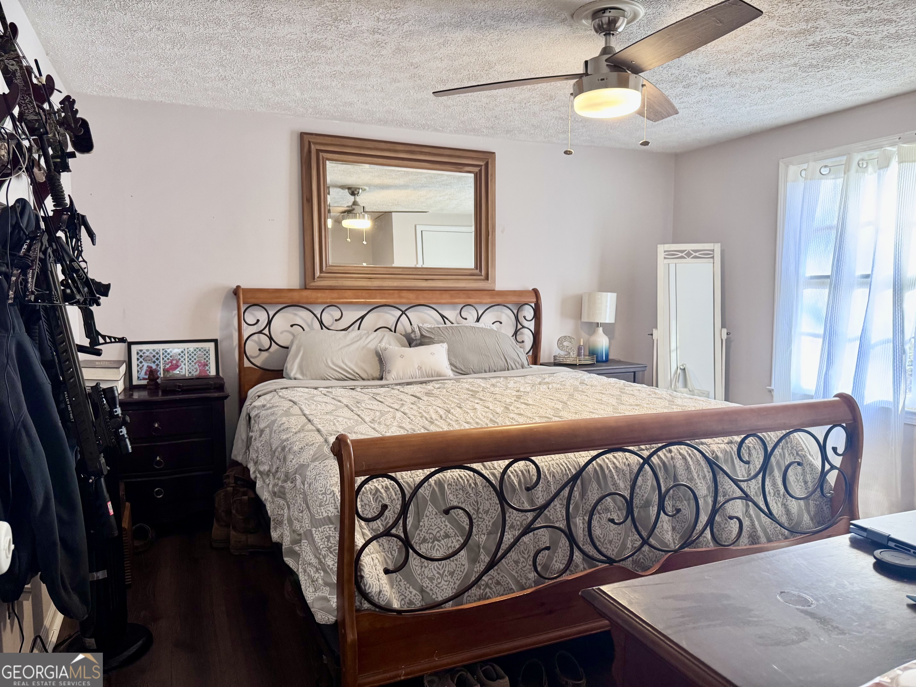 1335 Meadows Boone Road Luthersville, GA 30251 - Photo 11 of 20 a bedroom with a large bed and a chandelier