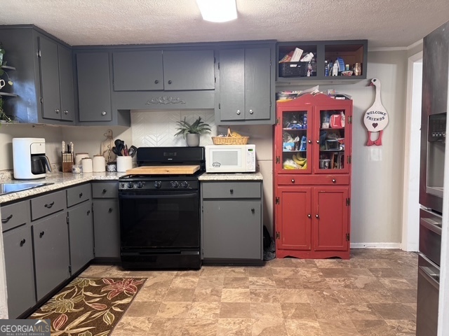 1335 Meadows Boone Road Luthersville, GA 30251 - Photo 4 of 20 a kitchen with stainless steel appliances granite countertop a stove a sink and a refrigerator
