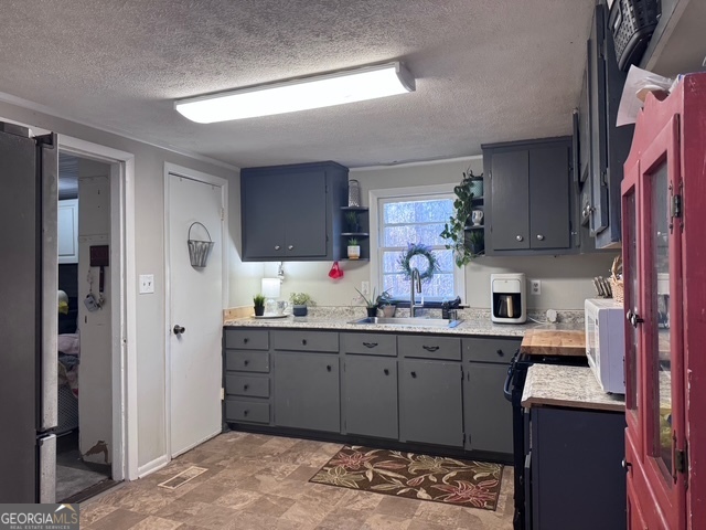 1335 Meadows Boone Road Luthersville, GA 30251 - Photo 5 of 20 a kitchen with a sink cabinets and wooden floor