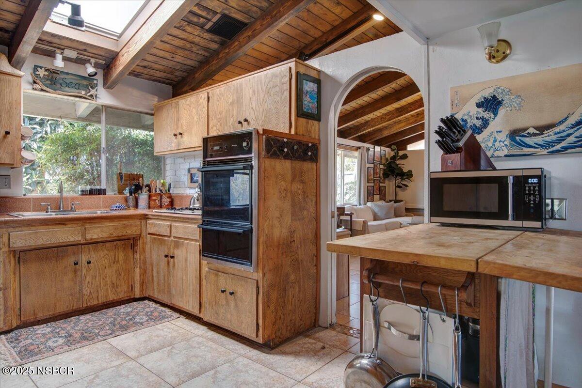 321 North Sixth Street Lompoc, CA 93436 - Photo 12 of 30 a kitchen with stainless steel appliances granite countertop a stove and a microwave