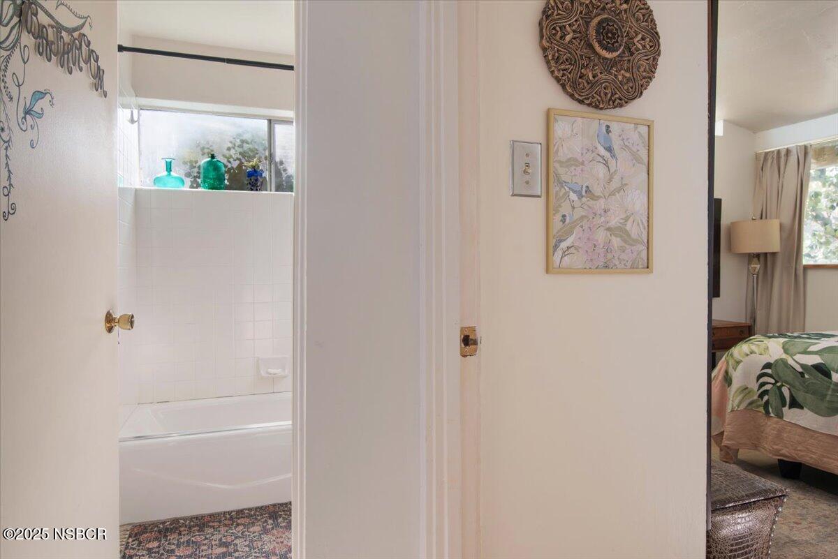 321 North Sixth Street Lompoc, CA 93436 - Photo 14 of 30 a bathroom with a bathtub and a window