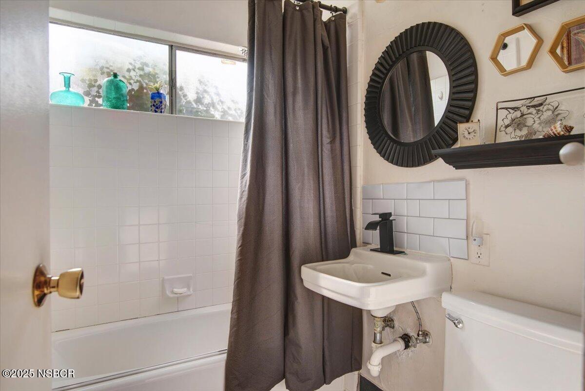 321 North Sixth Street Lompoc, CA 93436 - Photo 15 of 30 a bathroom with a sink a mirror and a window