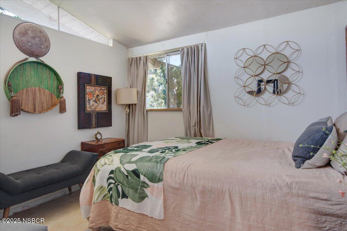 321 North Sixth Street Lompoc, CA 93436 - Photo 16 of 30 a bedroom with a bed and a painting on the wall