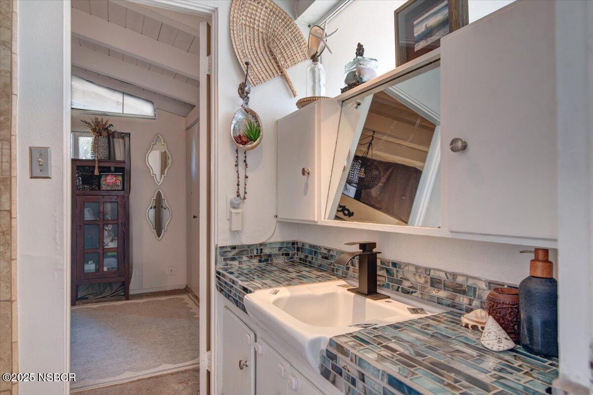321 North Sixth Street Lompoc, CA 93436 - Photo 18 of 30 a bathroom with a sink and a mirror