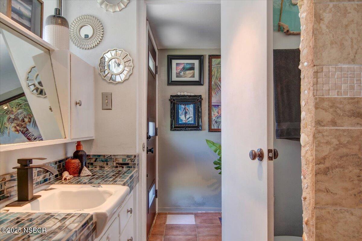 321 North Sixth Street Lompoc, CA 93436 - Photo 19 of 30 a bathroom with a sink and a mirror