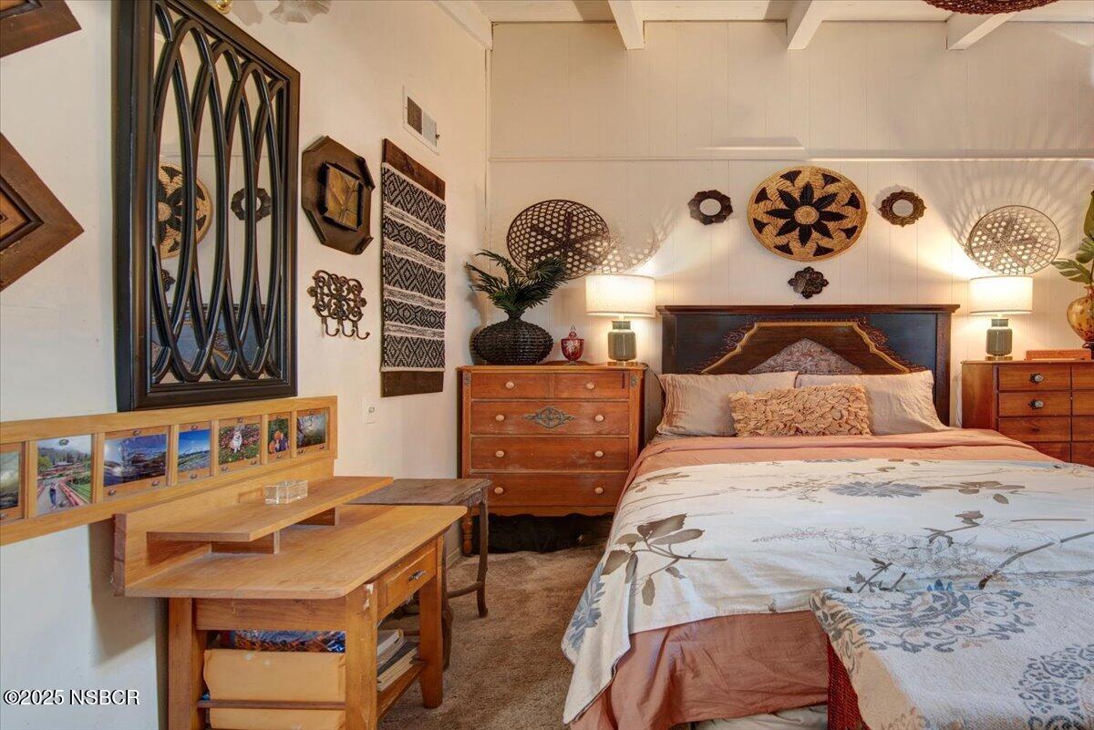 321 North Sixth Street Lompoc, CA 93436 - Photo 20 of 30 a bedroom with a bed and dresser with mirror