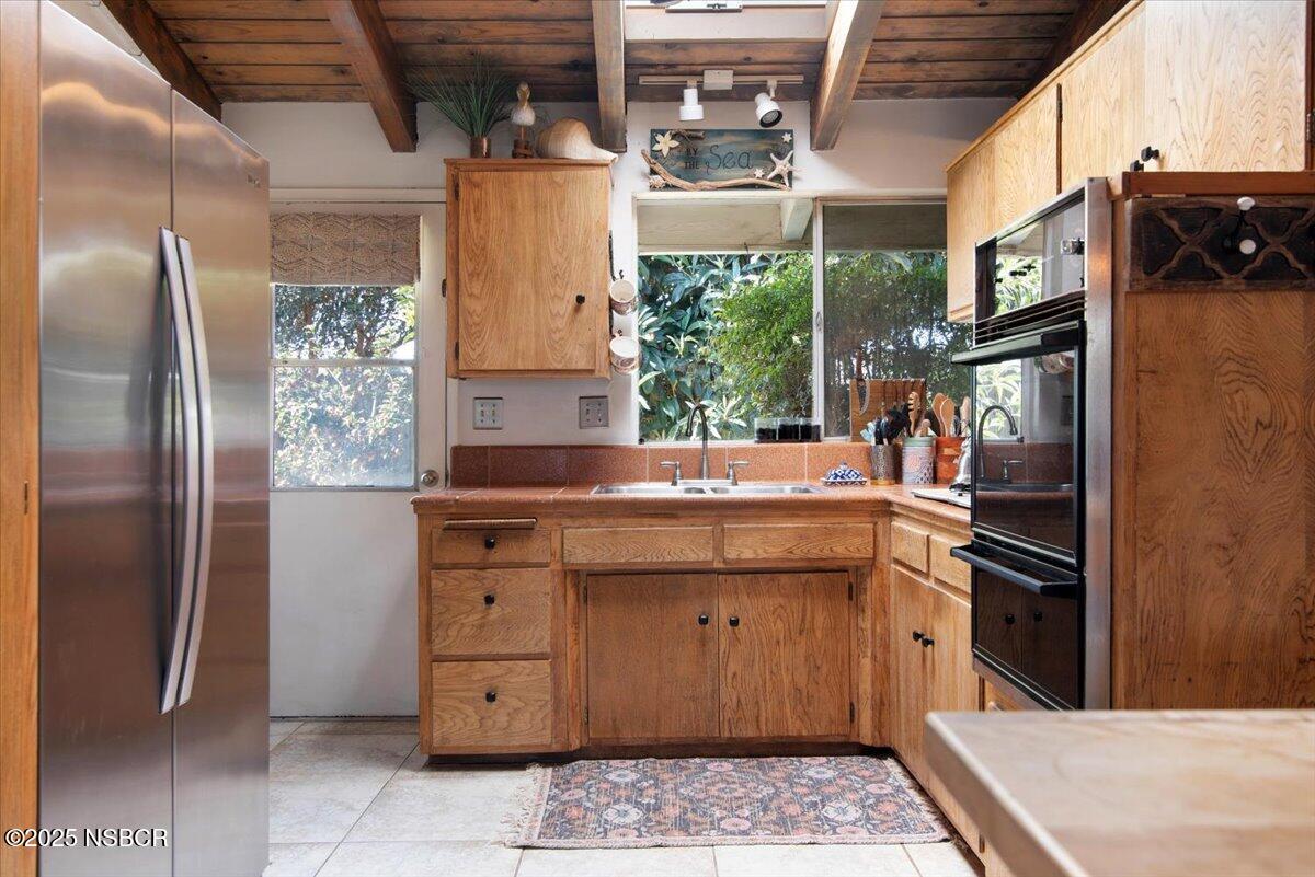 321 North Sixth Street Lompoc, CA 93436 - Photo 10 of 30 a kitchen with a sink refrigerator and microwave
