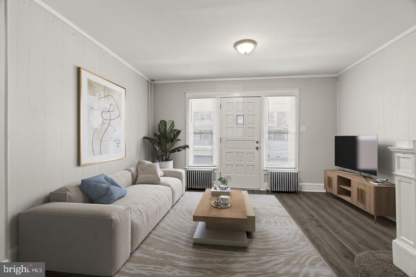 a living room with furniture and a flat screen tv