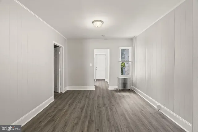 wooden floor in an empty room with a window