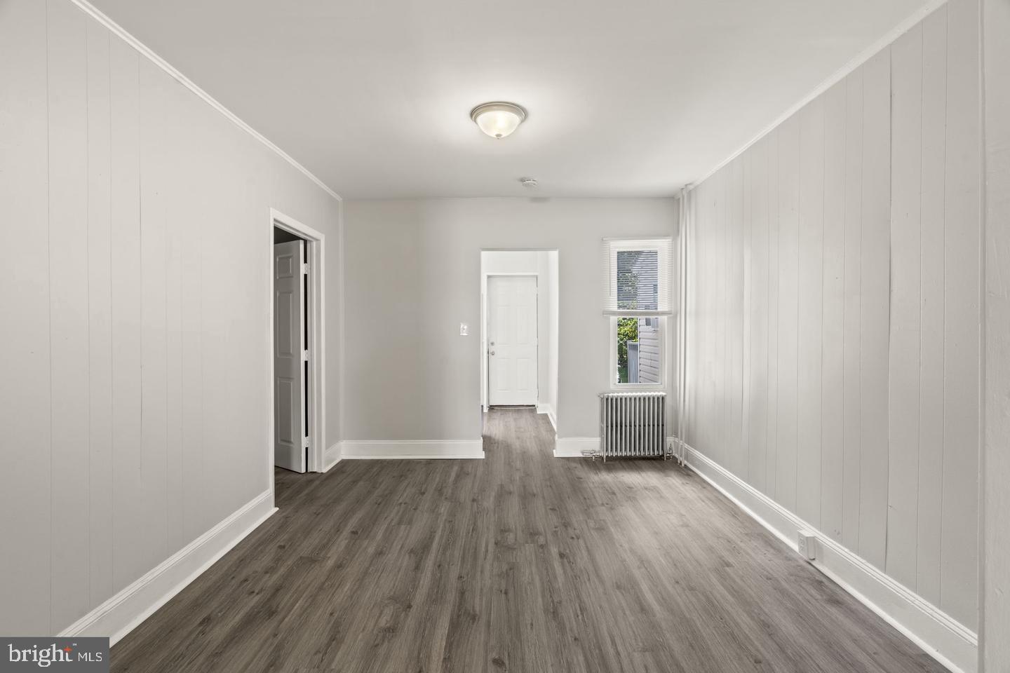 1213 West 9th Street Chester, PA 19013 - Photo 4 of 6 wooden floor in an empty room with a window