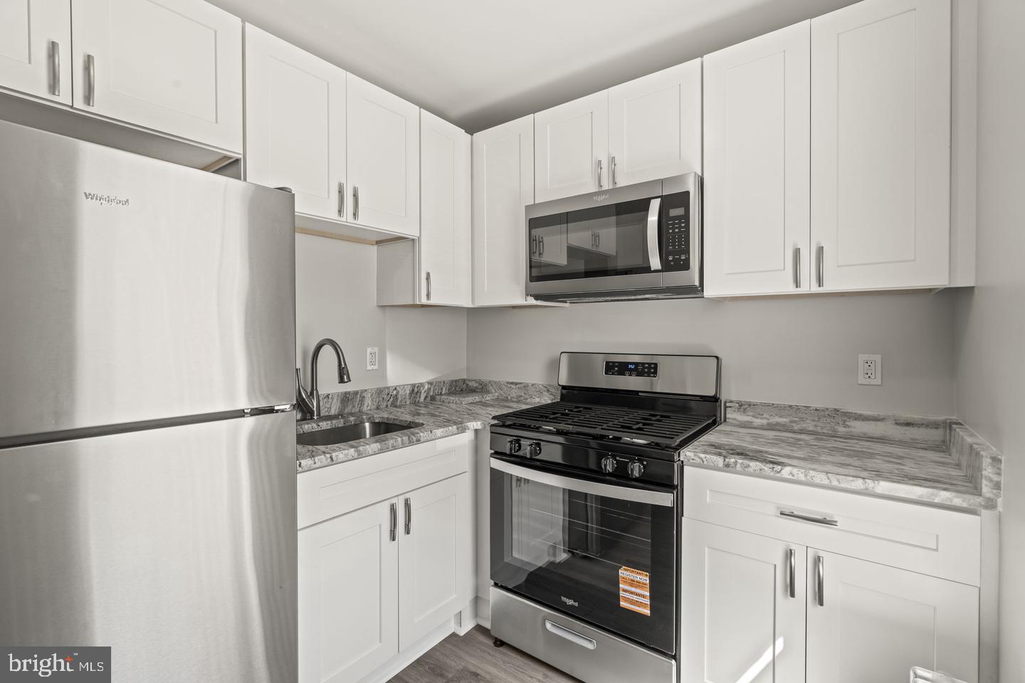 1213 West 9th Street Chester, PA 19013 - Photo 5 of 6 a kitchen with appliances a sink and cabinets