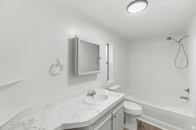 2875 North 400 West, Unit 7 Layton, UT 84041 - Photo 13 of 29 Bathroom featuring a single vanity with an integrated sink, patterned countertop, and undermount cabinetry