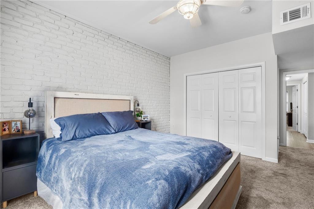 3675 Peachtree Road Northeast, Unit 45 Atlanta, GA 30319 - Photo 18 of 42 a bedroom with a large bed and a chandelier