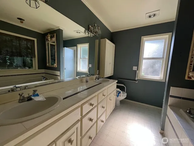 a bathroom with a double vanity sink and a mirror