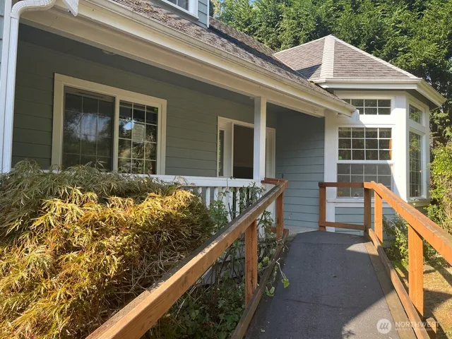 a view of house with wooden fence and two windows