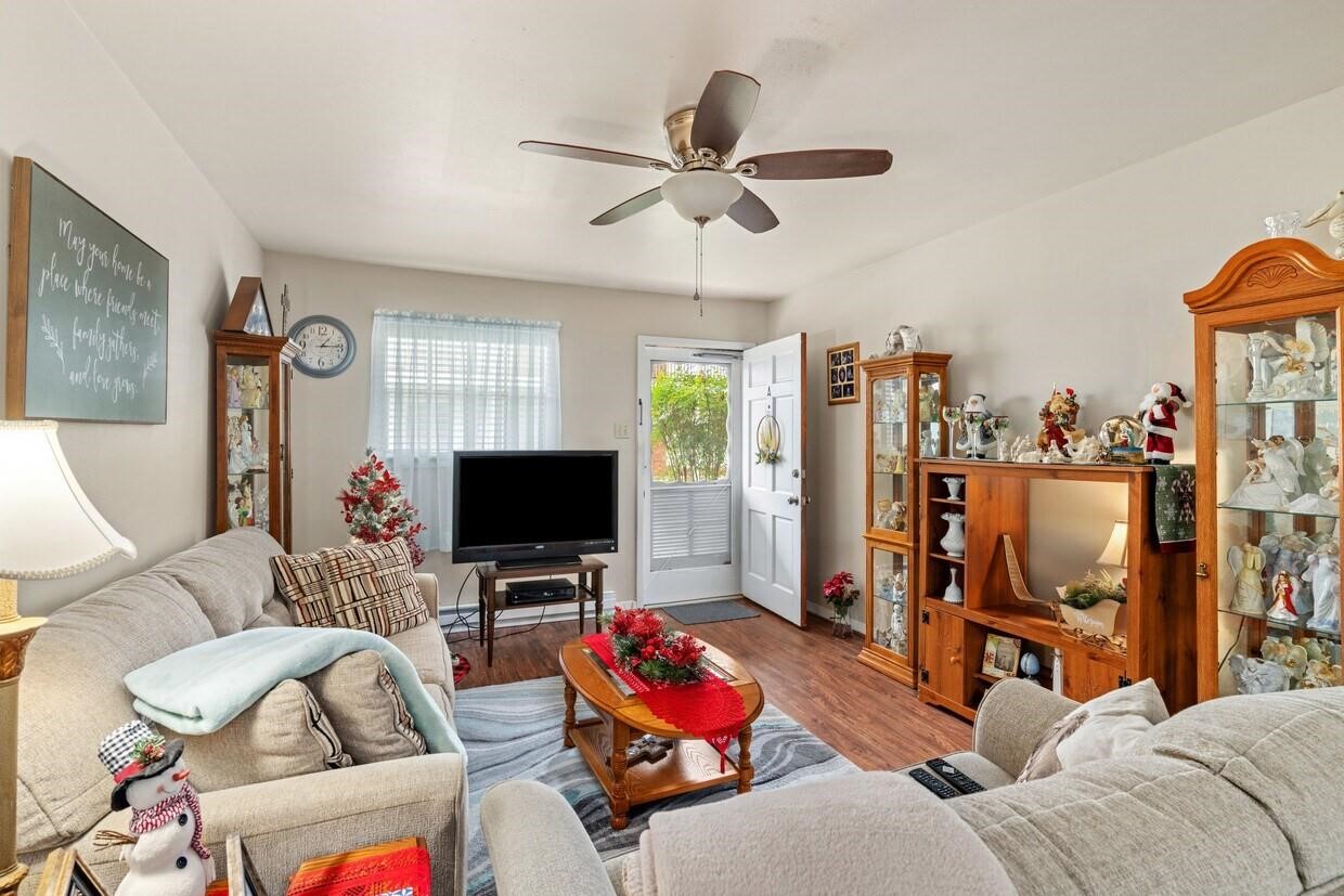 401 East Main Street, Unit 5 Brenham, TX 77833 - Photo 8 of 18 a living room with furniture a flat screen tv and a window