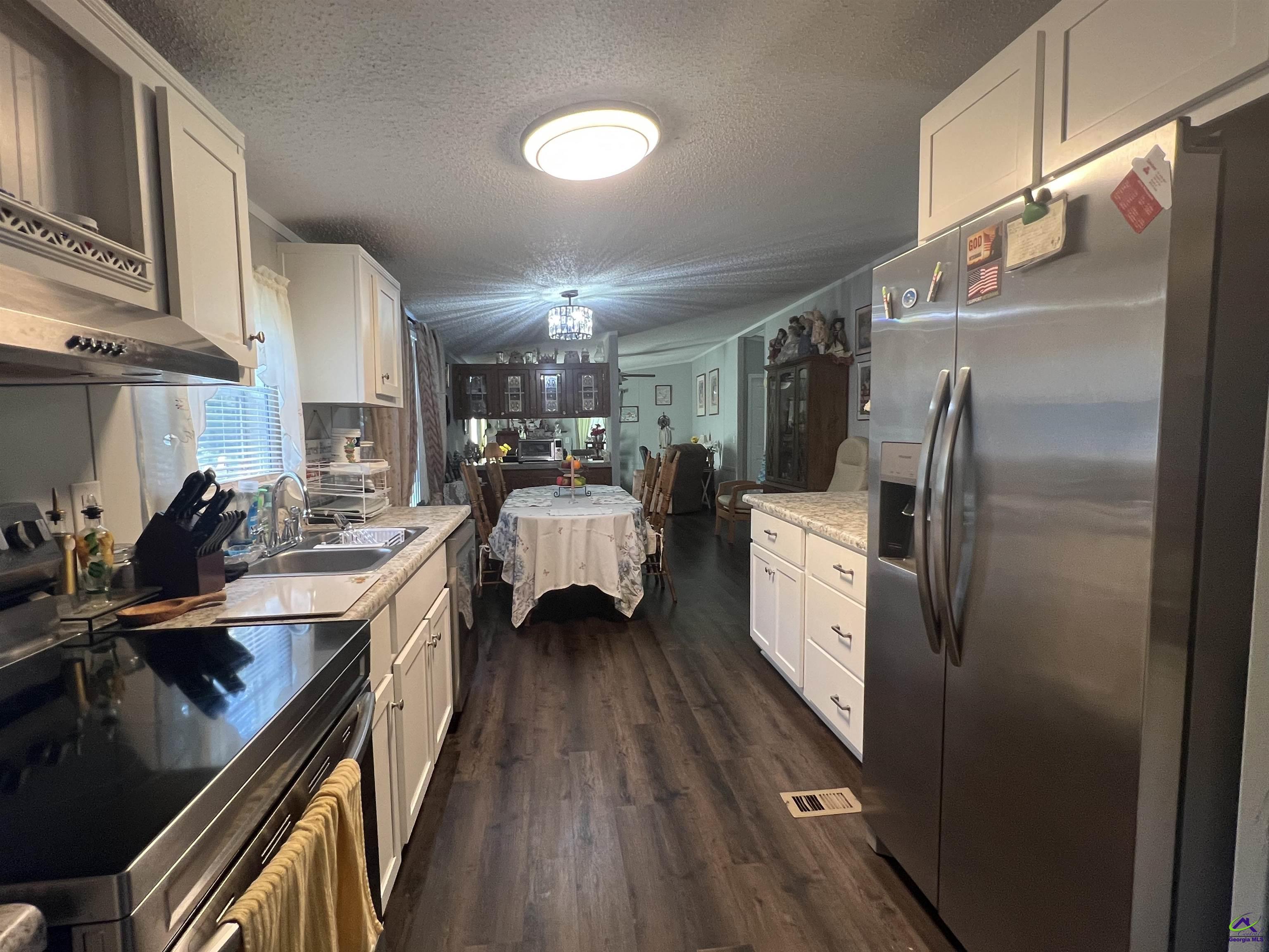 166 Pebble Hills Road Cochran, GA 31014 - Photo 9 of 27 a kitchen with a refrigerator and a sink