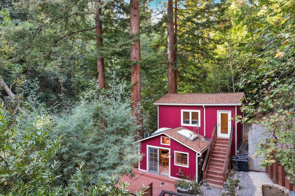 a front view of a house with a yard and balcony