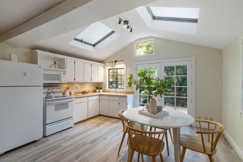 19495 Beardsley Road Los Gatos, CA 95033 - Photo 13 of 63 a kitchen with stainless steel appliances granite countertop a dining table chairs and white cabinets