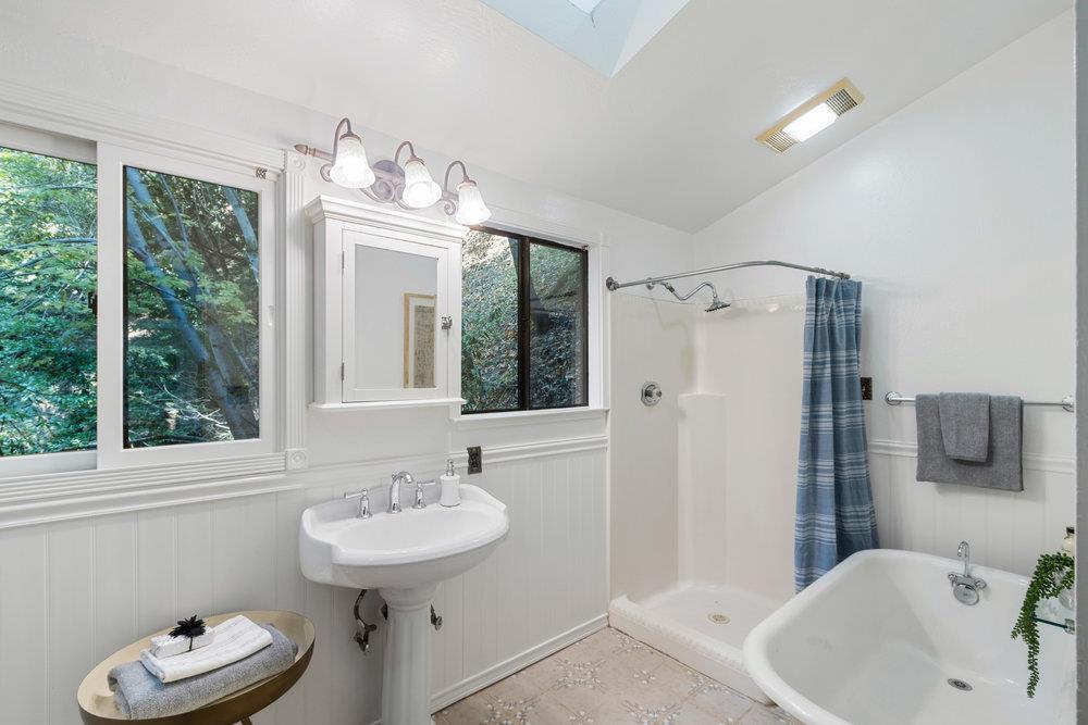 19495 Beardsley Road Los Gatos, CA 95033 - Photo 21 of 63 a bathroom with a sink a mirror and a window