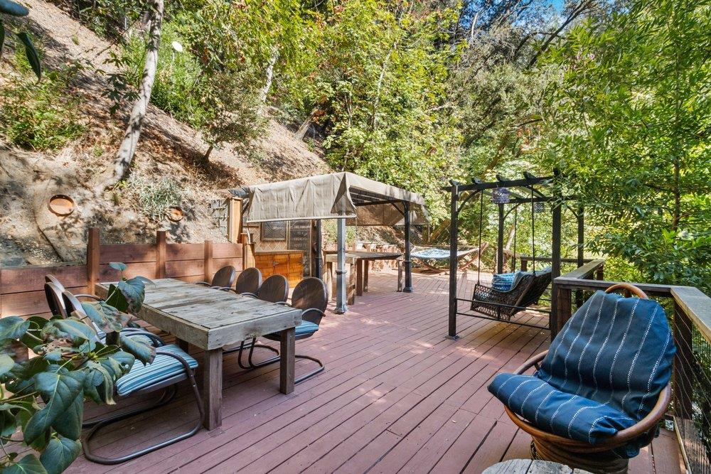 19495 Beardsley Road Los Gatos, CA 95033 - Photo 39 of 63 a view of a patio with table and chairs potted plants and a large tree