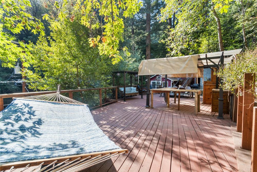 19495 Beardsley Road Los Gatos, CA 95033 - Photo 44 of 63 a view of a roof deck with table and chairs a barbeque with wooden floor and fence