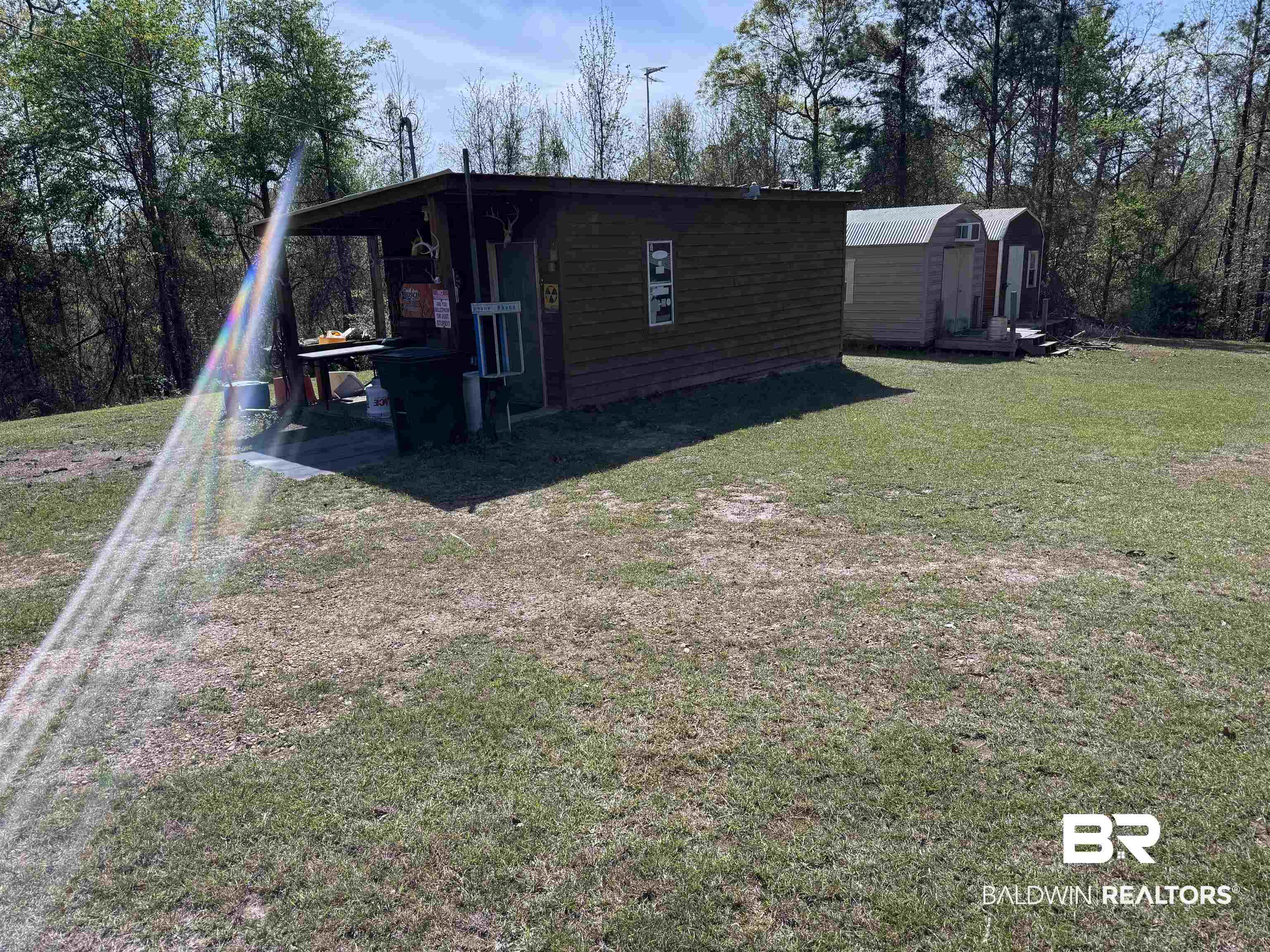 516 Mill Creek Road Frisco City, AL 36445 - Photo 22 of 32 Rear view of house featuring a shed and a yard