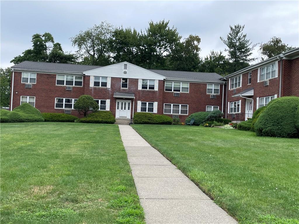 231 North Middletown Road, Unit G Pearl River, NY 10965 - Photo 1 of 1 a front view of a house with garden