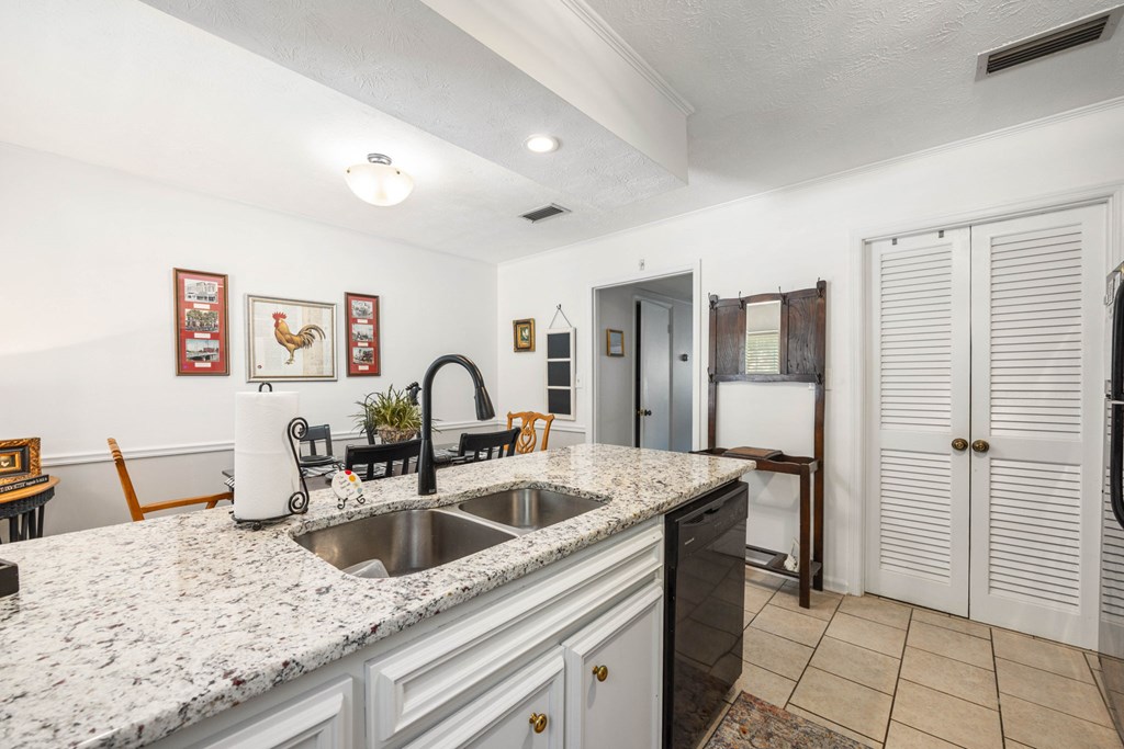 6101 River Road, Unit 15 Columbus, GA 31904 - Photo 11 of 22 a kitchen with stainless steel appliances granite countertop a sink and a refrigerator