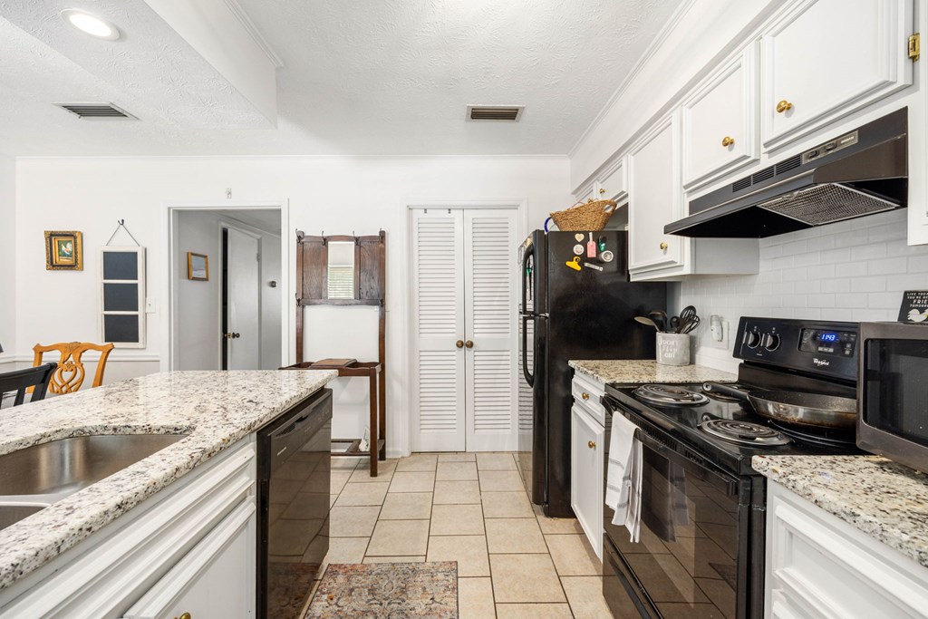 6101 River Road, Unit 15 Columbus, GA 31904 - Photo 12 of 22 a kitchen with stainless steel appliances granite countertop a sink stove and refrigerator