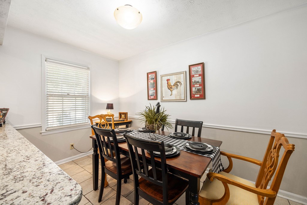 6101 River Road, Unit 15 Columbus, GA 31904 - Photo 13 of 22 a view of a dining room with furniture and wooden floor