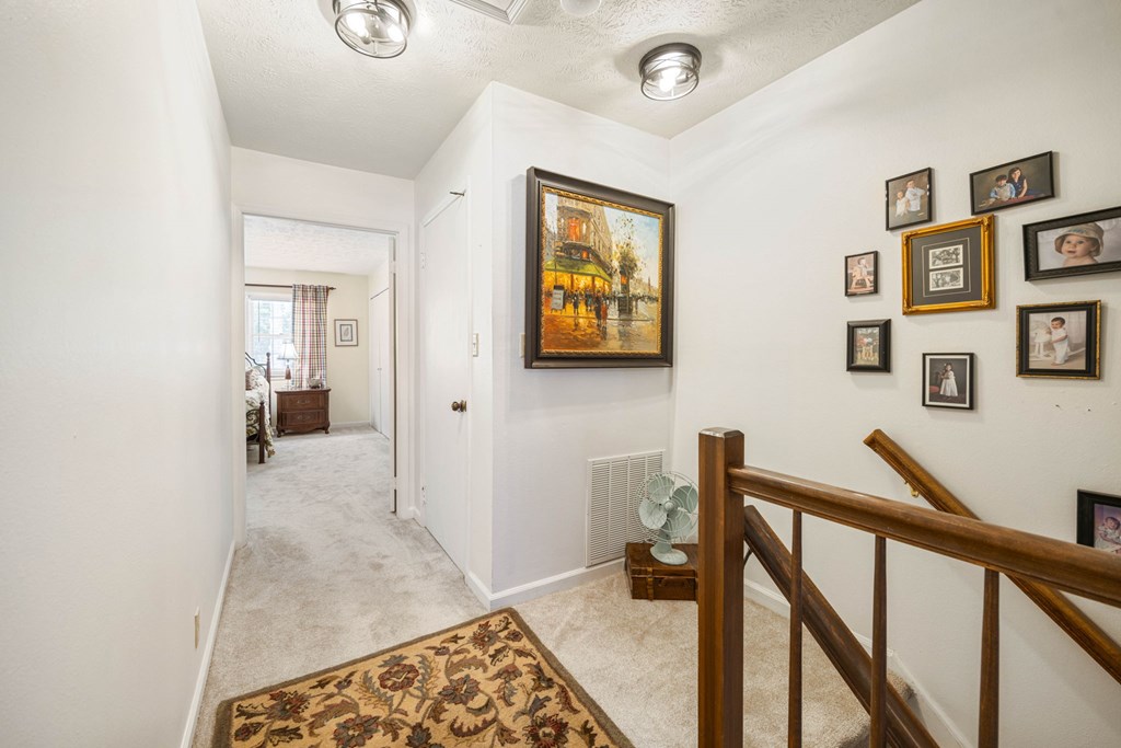 6101 River Road, Unit 15 Columbus, GA 31904 - Photo 14 of 22 a view of a hallway with furniture and paintings on the wall