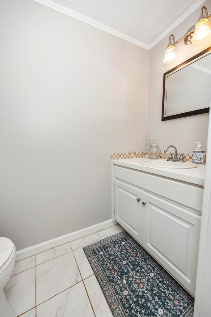 6101 River Road, Unit 15 Columbus, GA 31904 - Photo 21 of 22 a bathroom with a sink toilet and mirror