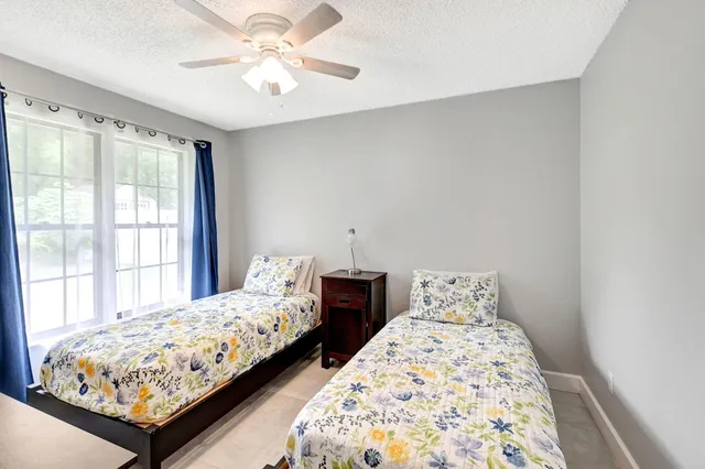a bedroom with a large bed and wooden floor