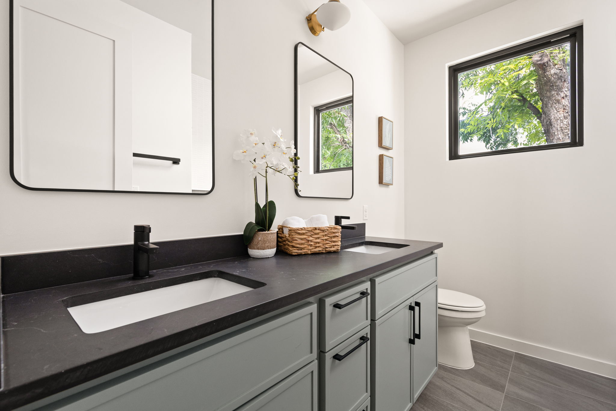 2717 Lyons Road, Unit 1 Austin, TX 78702 - Photo 25 of 40 A well-appointed primary bathroom features dual vanities, modern fixtures, and a naturally illuminated window.