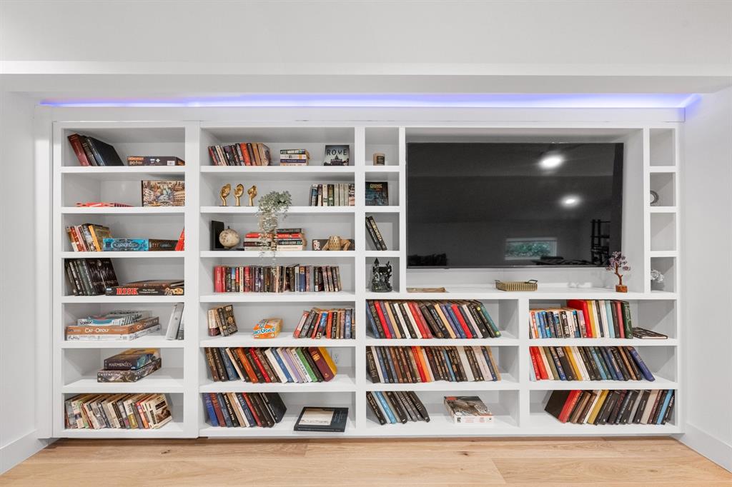 4604-2 Santa Anna Street Austin, TX 78721 - Photo 4 of 7 a living room with a bookshelf and a flat screen tv