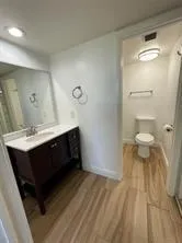 a bathroom with a sink a toilet and a mirror