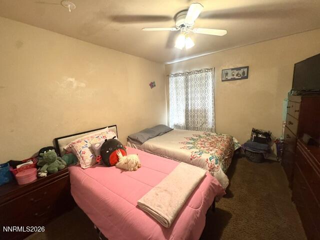 1557 Delucchi Lane, Unit G Reno, NV 89502 - Photo 4 of 8 a bedroom with a bed and a flat screen tv
