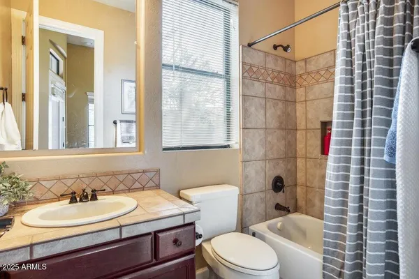 a living room with furniture a flat screen tv and a large window