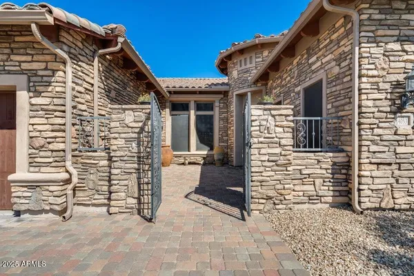 an aerial view of a house with a mountain