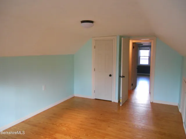 a view of hallway with wooden floor
