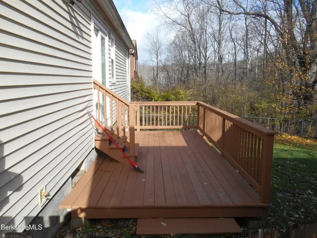 a view of balcony with wooden floor and fence