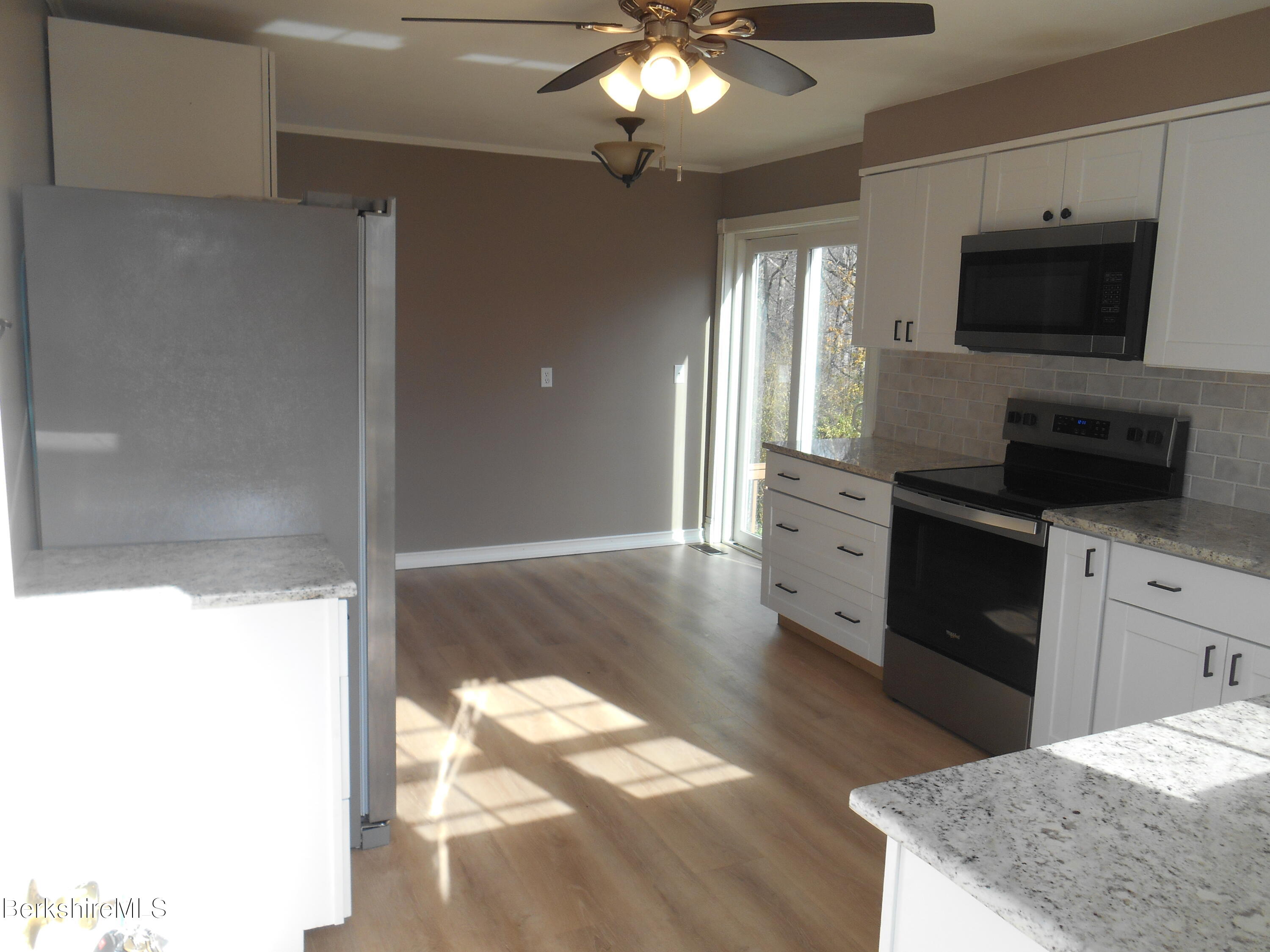 14 Glassworks Road Lanesborough, MA 01224 - Photo 4 of 23 a kitchen with a refrigerator and a stove top oven