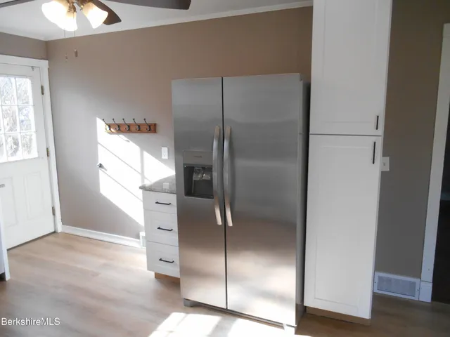 a kitchen with a refrigerator and window