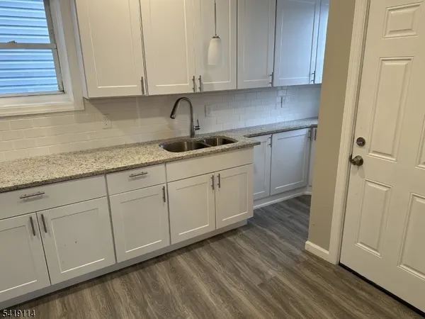 a kitchen with stainless steel appliances granite countertop a sink and cabinets