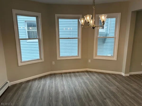 a view of a room with wooden floor and windows