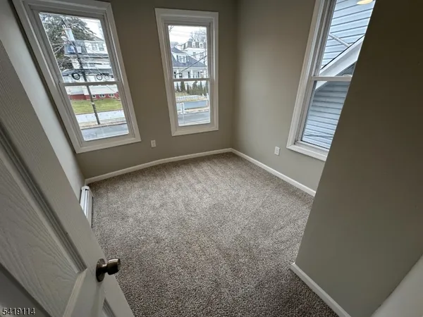 a view of an empty room with windows