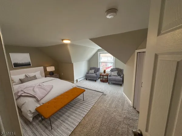 a living room with furniture a mirror and a lamp