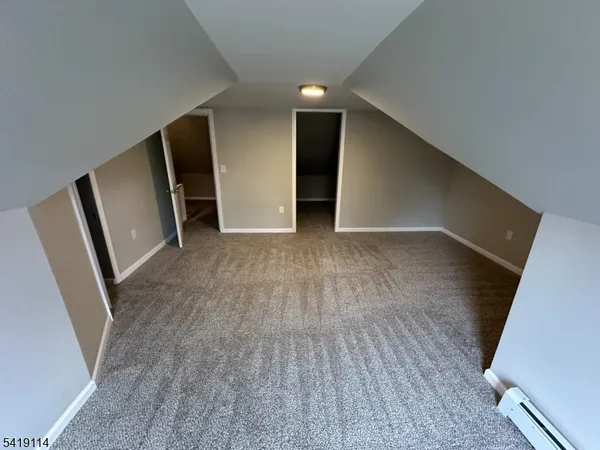 a view of empty room with wooden floor and window