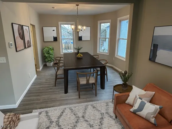 a living room with furniture wooden floor and a chandelier